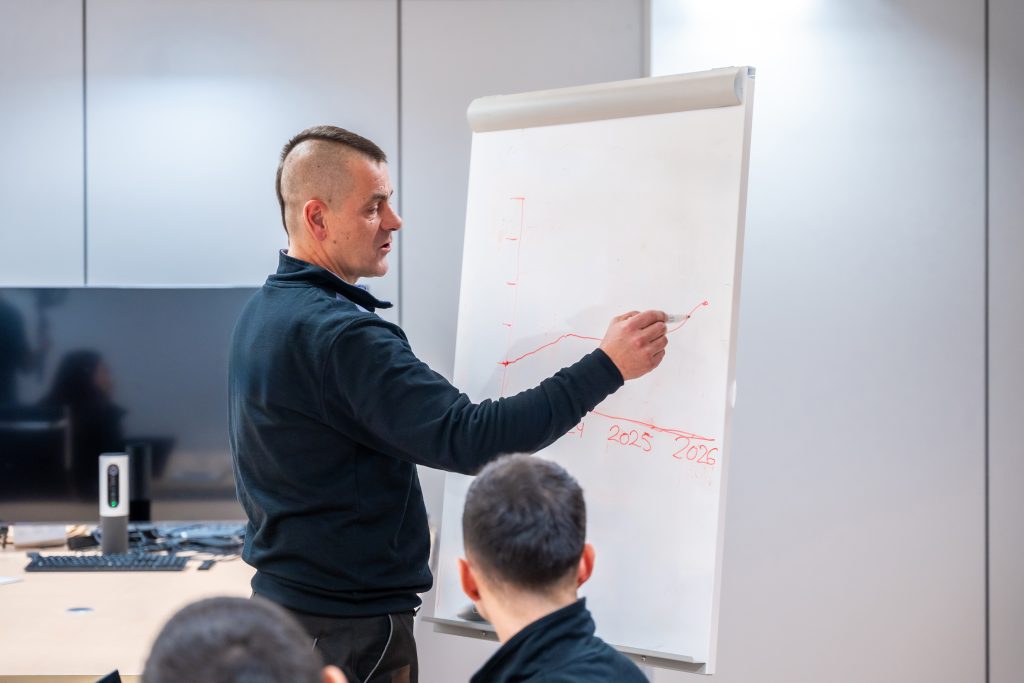 Security Awareness Training Engineers using a board during a brainstorming in a meeting room in a factory